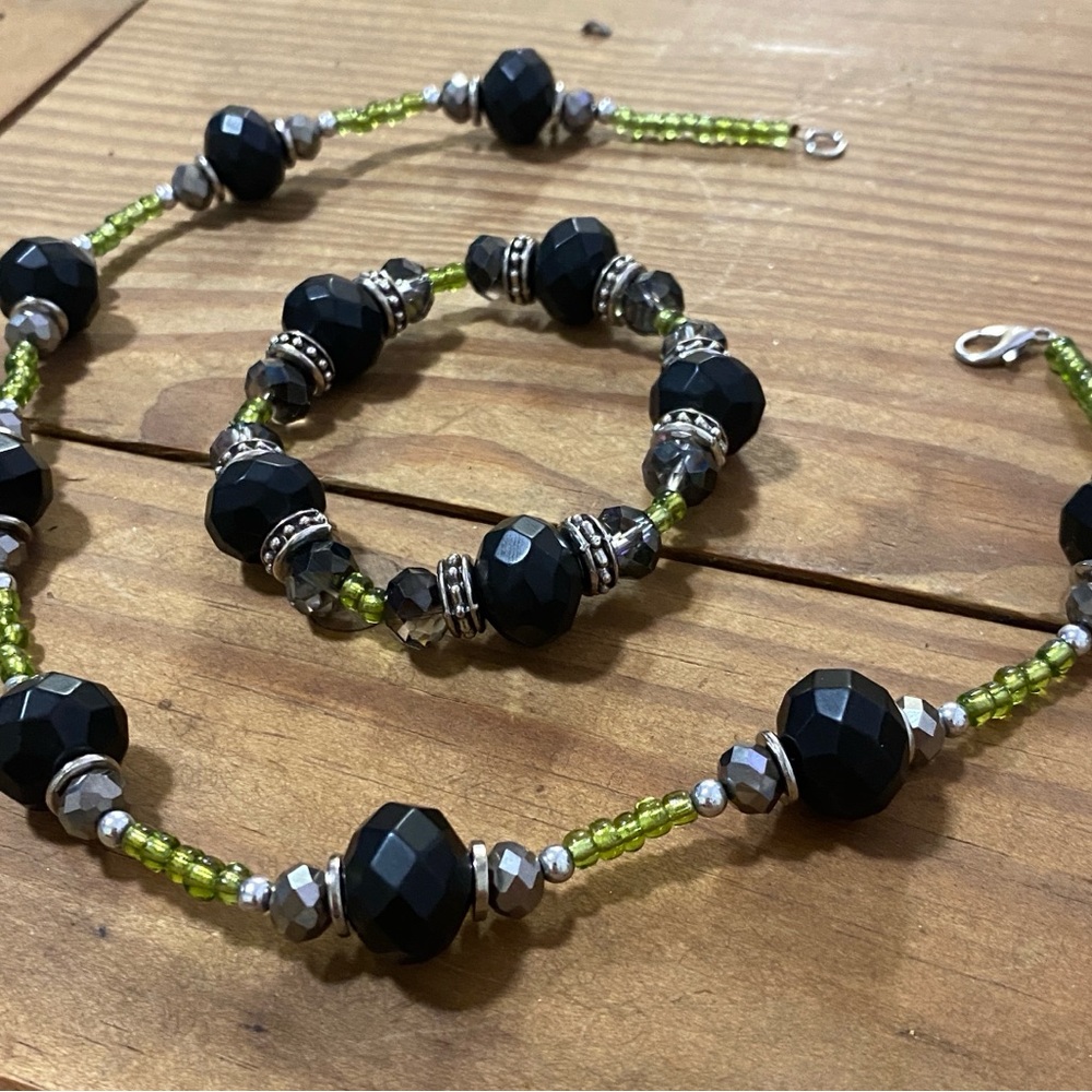Black obsidian beaded necklace with green accent beads.